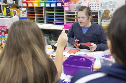Students with special needs in Catholic schools
A student talks with other students in an art class