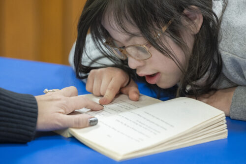 Students with special needs in Catholic schools
A student reads a book with the assistance of a paraprofessional.