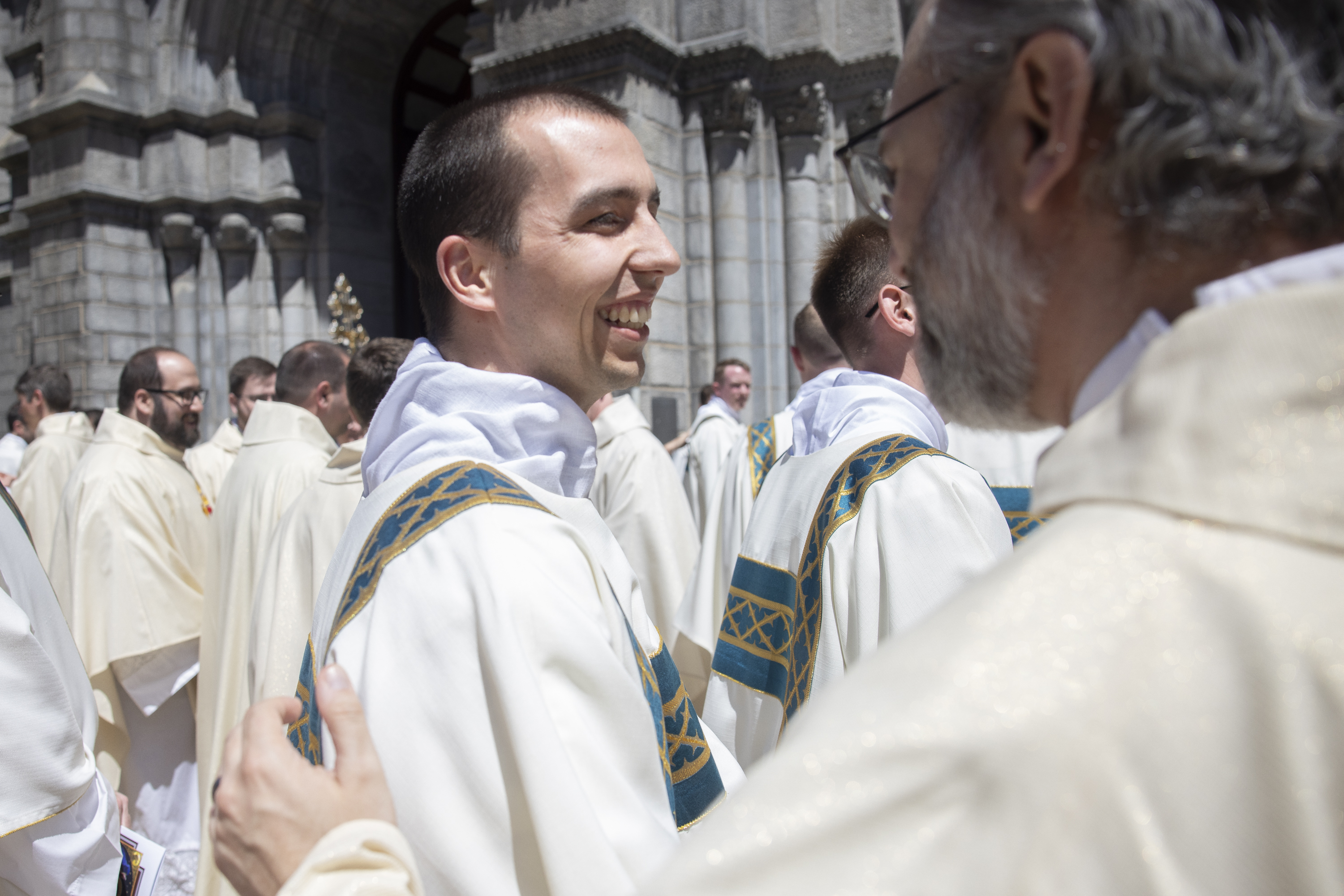 Deacon Mark Koenemann was congratulated by clergy after his ordination to the transitional diaconate.