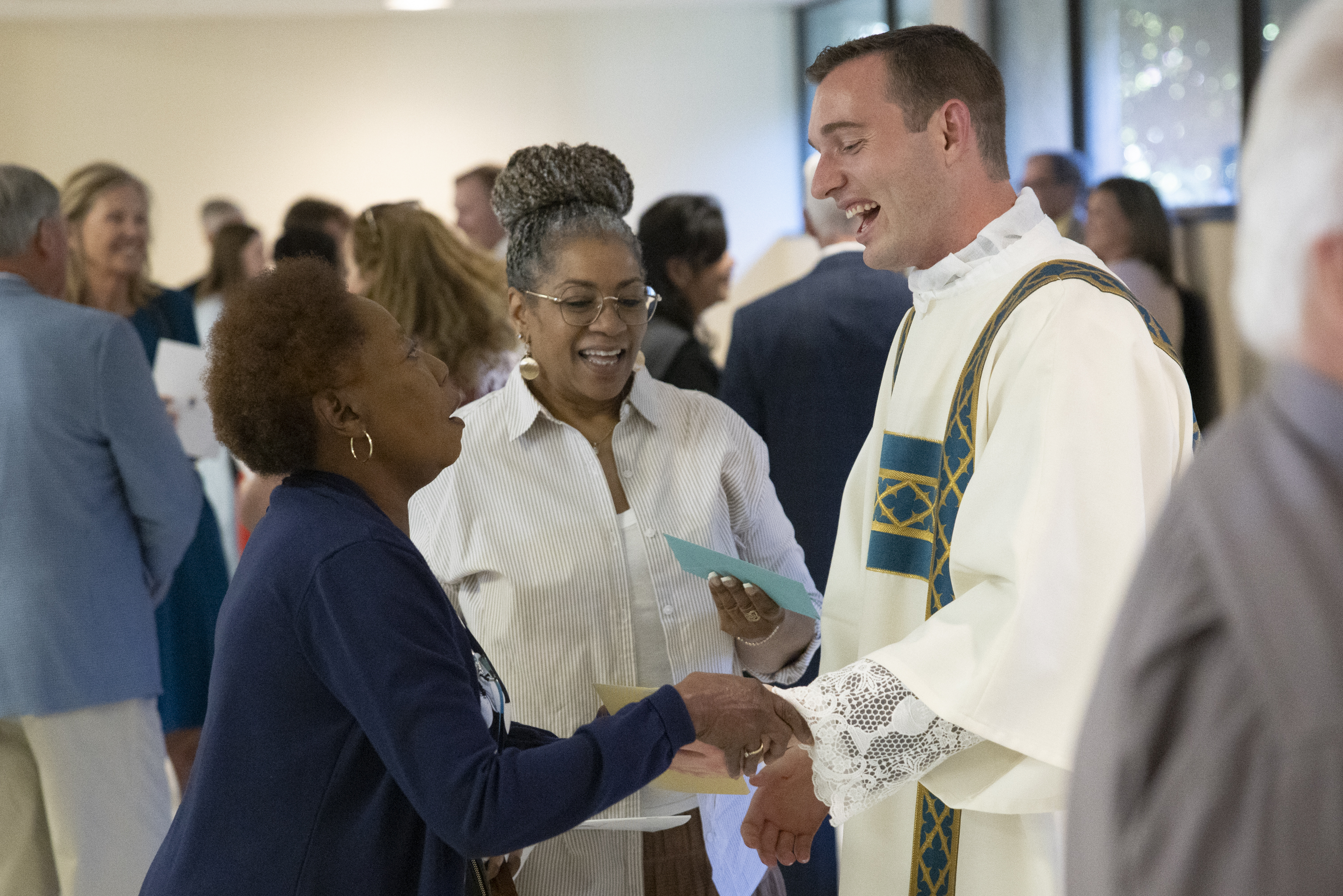 Deacon Curtis Prize met with attendees at a reception following his ordination.