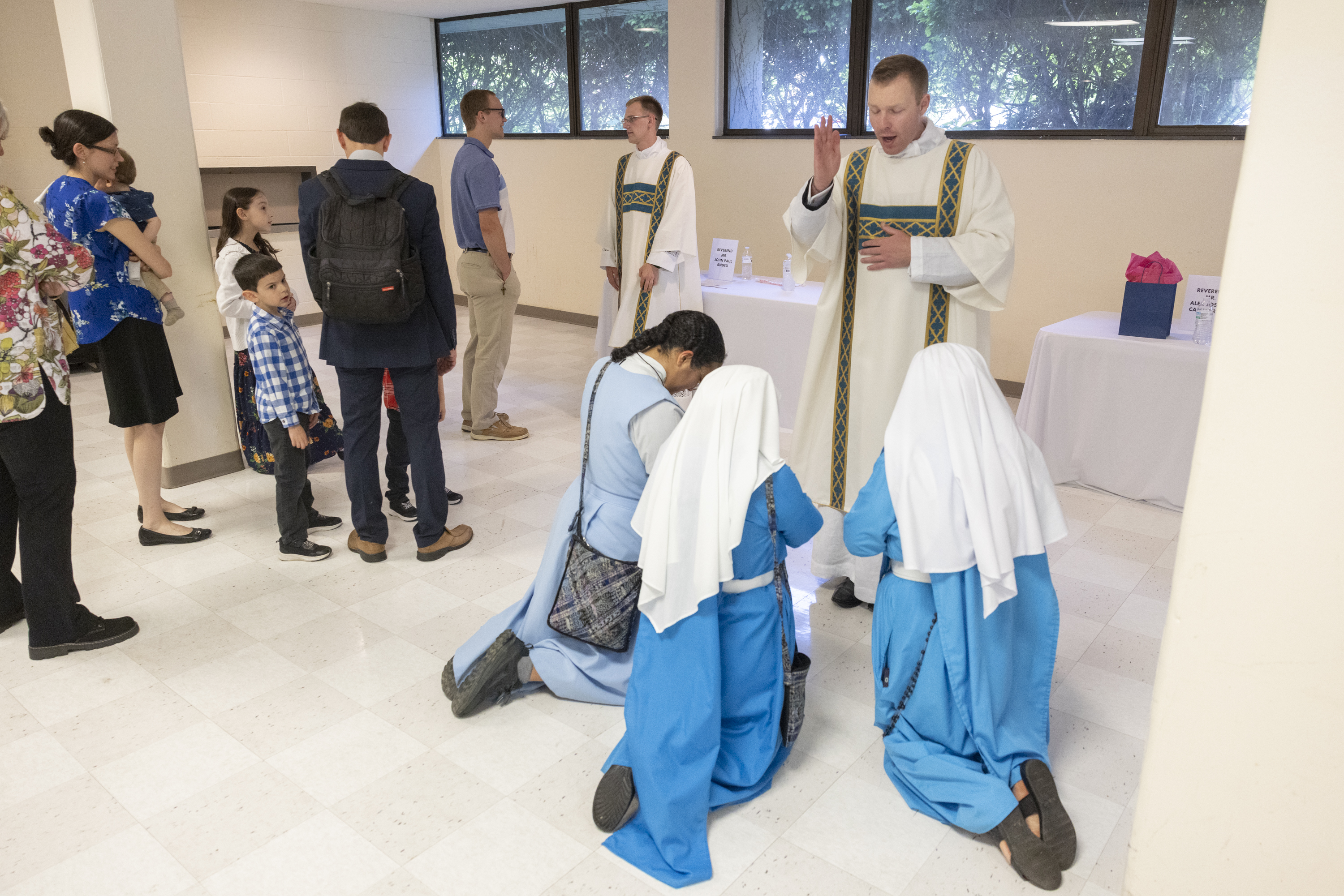 Deacon Alex Cammarata gives a blessing at a reception after his ordination.