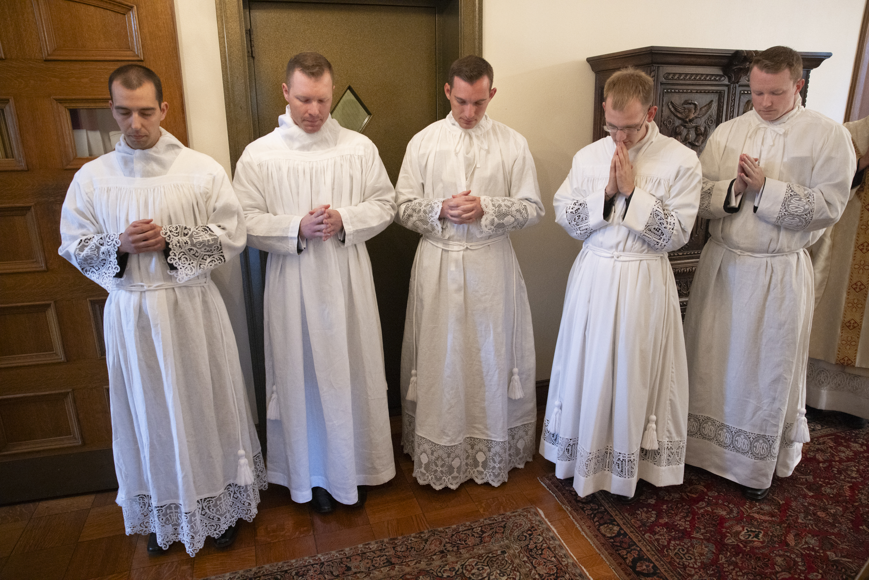 Seminarians prayed before the start of their ordination mass.